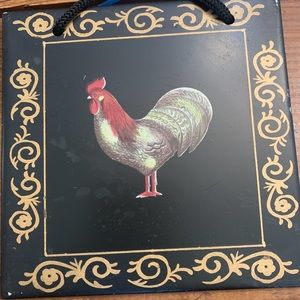 Rooster picture on black tile